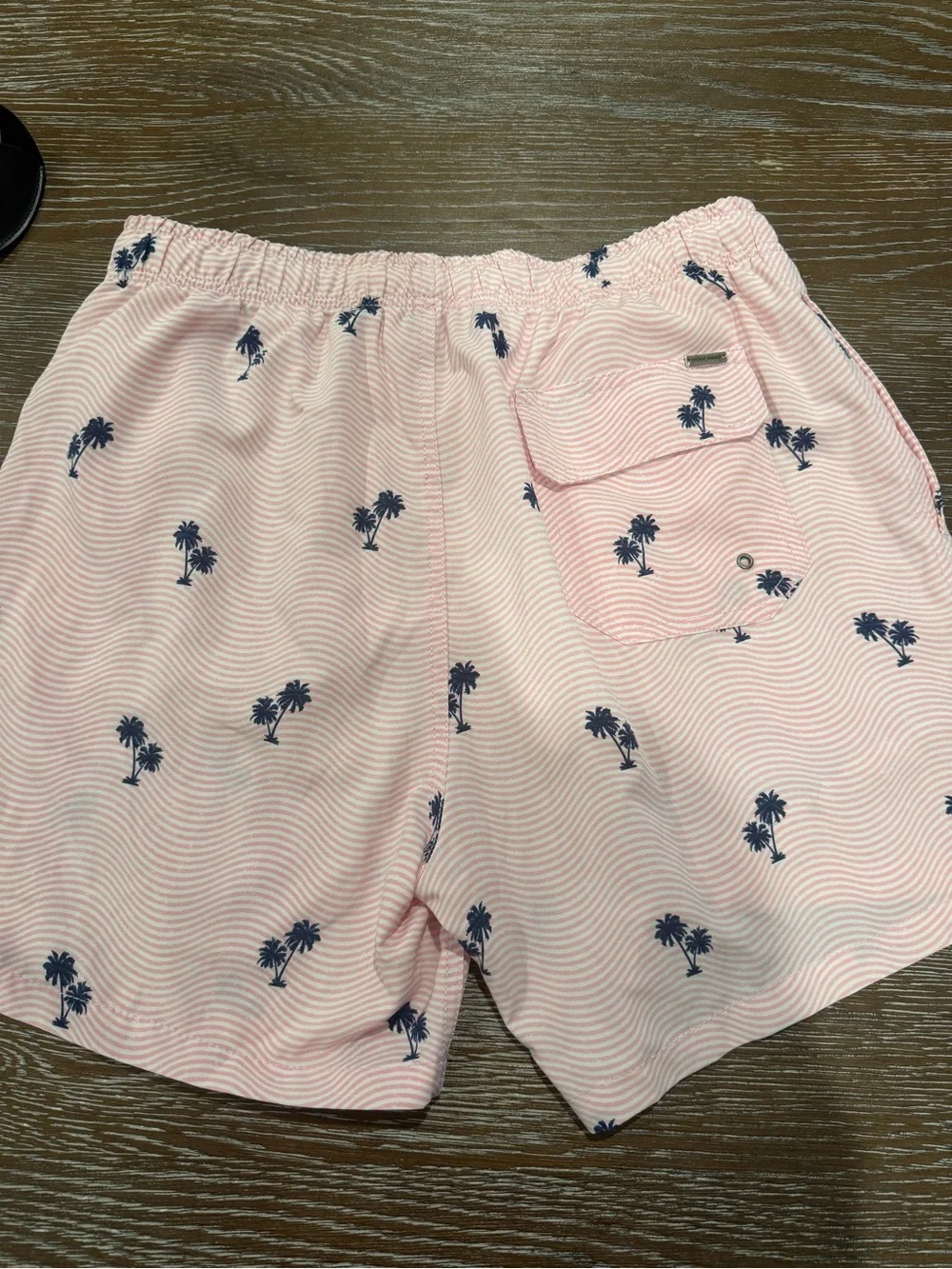 Pink swim trunks with palm trees